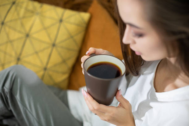 istock Cozy Moment A Woman Relaxing While Enjoying Her Coffee in a Calm and Inviting Setting 2187230972