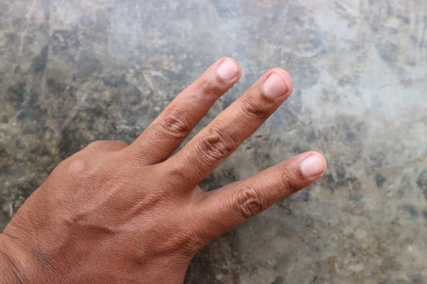 fingers placed on the cement floor