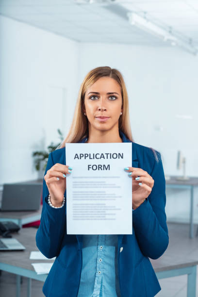 istock Young businesswoman holding application form in office 2187240105
