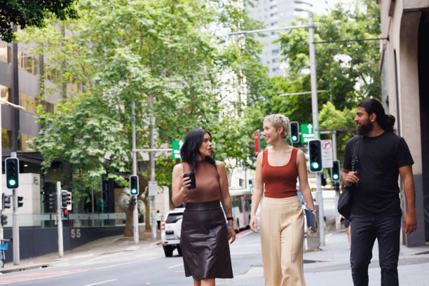 istock Three colleagues chatting and walking through the city on their way to work 2187240785