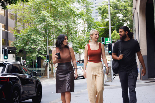 istock Three colleagues chatting and walking through the city on their way to work 2187240788