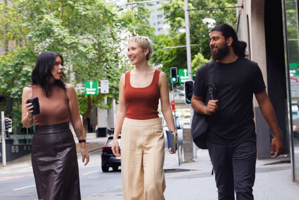 istock Three colleagues chatting and walking through the city on their way to work 2187240829