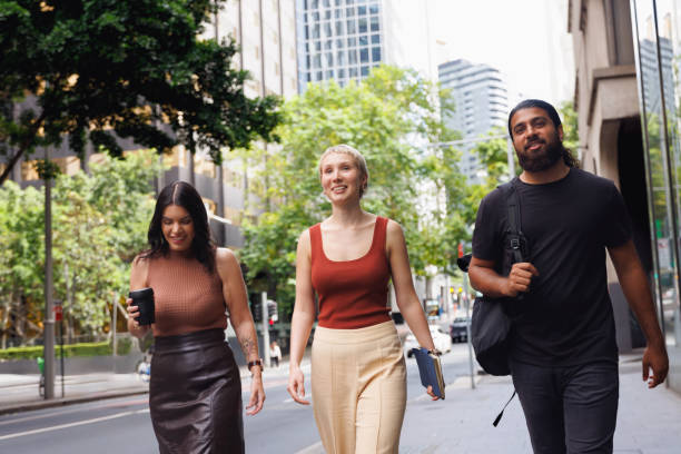 istock Three colleagues chatting and walking through the city on their way to work 2187240892