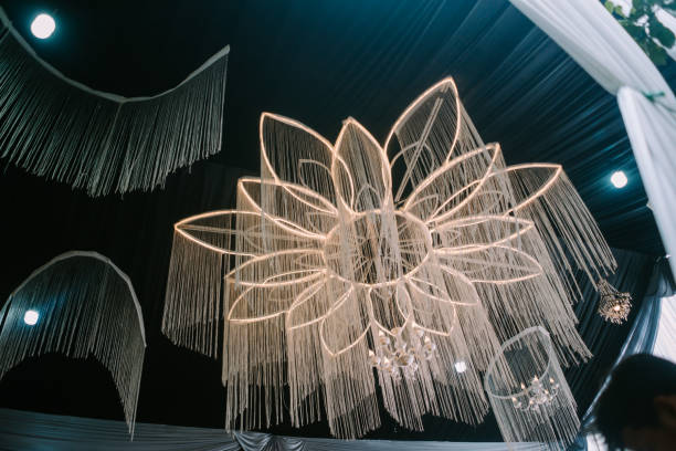 istock Floral chandelier with lights and fringes, adding elegance to a dark-ceiling venue 2187240969