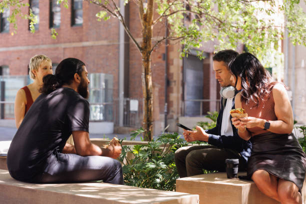 istock Four colleagues enjoying their lunch break outdoors 2187241656