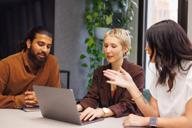 istock Three colleagues conducting a casual meeting in boardroom 2187242940