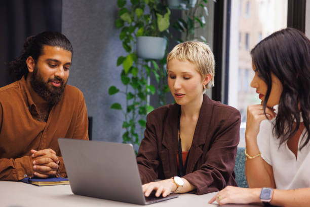 istock Three colleagues conducting a casual meeting in boardroom 2187243063