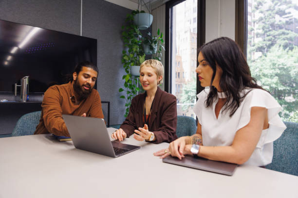 istock Three colleagues conducting a casual meeting in boardroom 2187243075