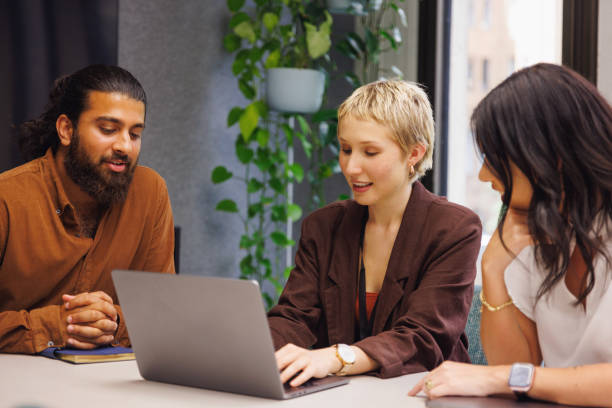 istock Three colleagues conducting a casual meeting in boardroom 2187243109