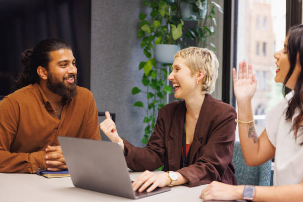 istock Three colleagues conducting a casual meeting in boardroom 2187243110