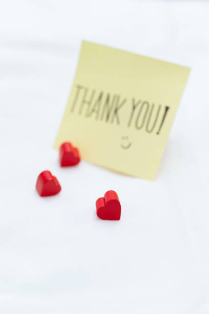 istock Gratitude in business thank you note with hearts on a table warm workspace close-up perspective emotional connection for seo impact 2187244814