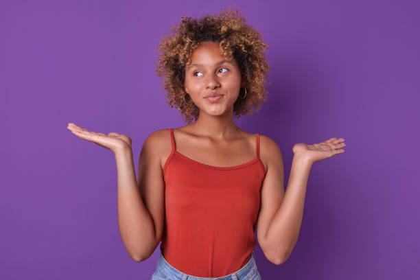 istock Young Woman Expressing Curiosity Against a Vibrant Purple Backdrop 2187245000