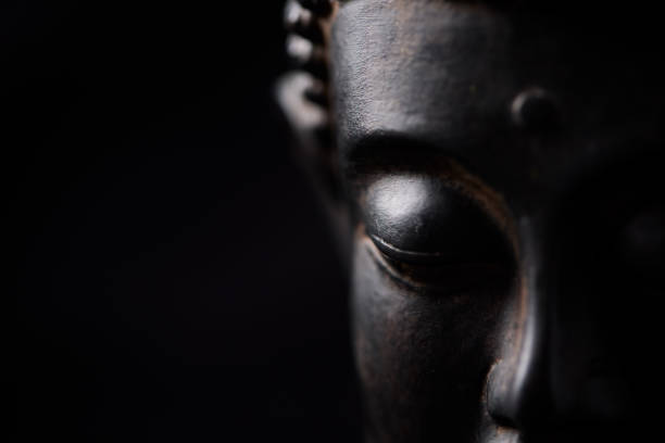 istock Meditating Buddha Statue on dark background. Soft focus. Close up. Copy space. 2187247317