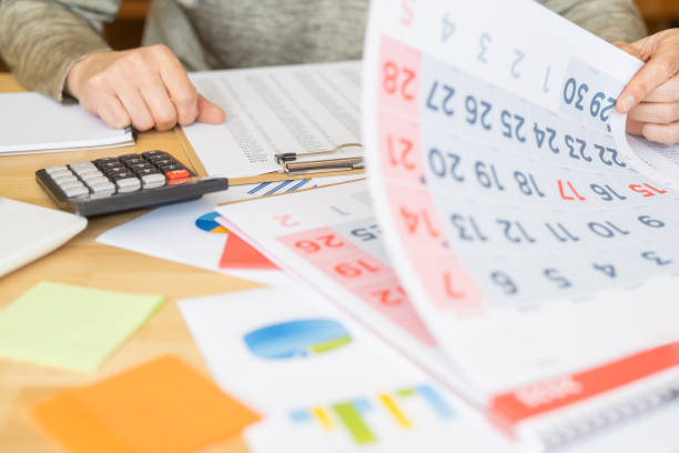 istock Business Professional Planning and Organizing Daily, Weekly, and Monthly Tasks Using a Calendar for Work, Personal Activities, Appointments, and Vacations. Concept of Time Management and Organization. 2187248619