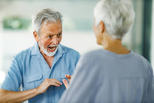Picture of a cute elderly couple kissing at home