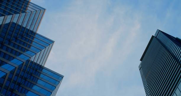 istock Skyscrapers Stretching Upward Towards Blue Sky Reflecting Modern Architecture Capturing Urban Perspective With Stunning Vertical Designs In Cityscape Of Glass Structures And HighRise Buildings 2187249433