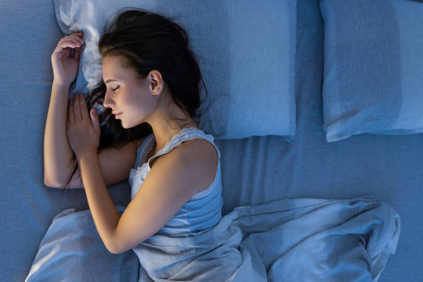 istock Woman sleeping in bed 2187250009