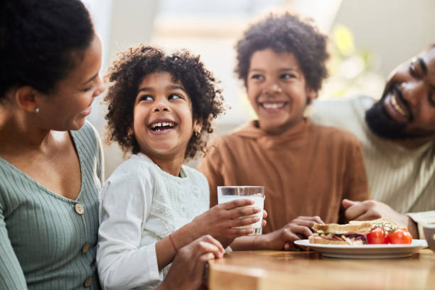 istock Happy black family enjoying in breakfast at dining table. 2187250073