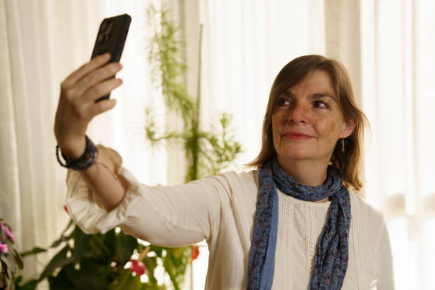 istock Woman Taking a Selfie in a Bright Room 2187250796
