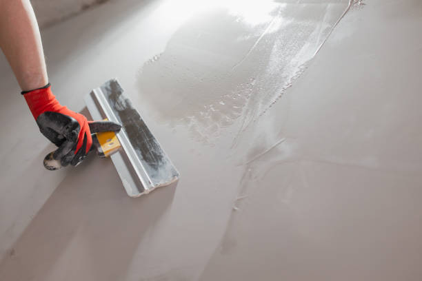 istock The hand of a craftsman with a spatula during work on leveling a wall with putty 2187251731