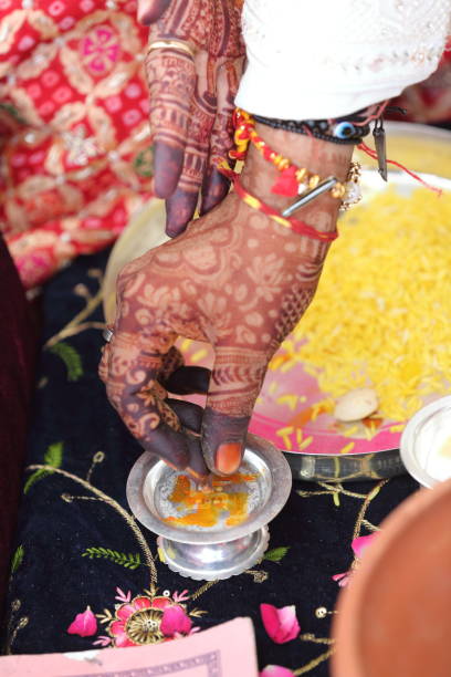 Offering prayers to the holy fire during a Hindu wedding ceremony.