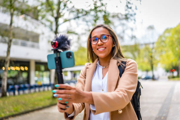 istock Vlogger smiling while recording new content in the city 2187252374