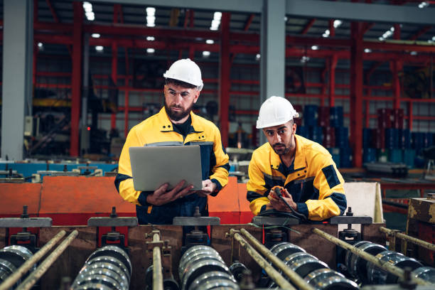 istock Industrial man engineer using laptop are checking system machine at factory. 2187256261