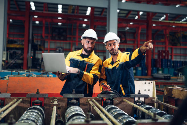 istock Industrial man engineer using laptop are checking system machine at factory. 2187256280