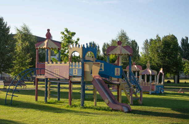 istock A vibrant playground features slides and climbing structures, surrounded by lush trees and grassy areas, where children enjoy playtime under the sun 2187256563