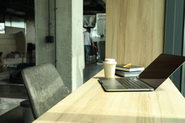 istock A laptop with documents, notebooks and a cup of coffee on the table 2187257444