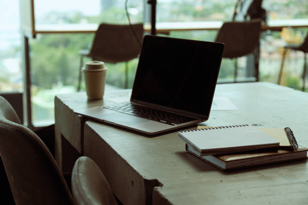 istock A laptop with documents, notebooks and a cup of coffee on the table 2187257534