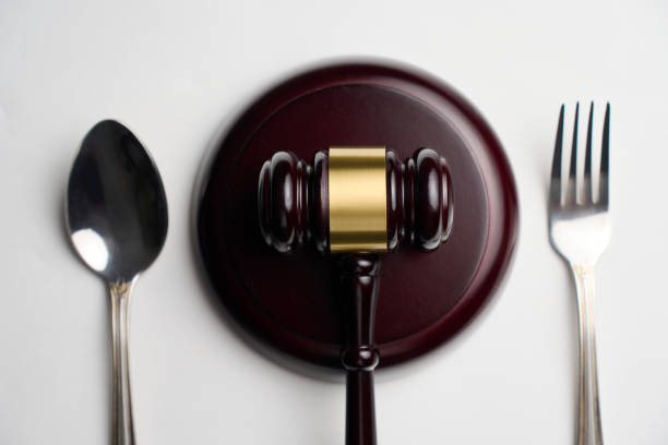 istock Judges gavel with fork and spoon on a white background with copy space, close-up. Sanitary inspection, food law and justice concept 2187258784