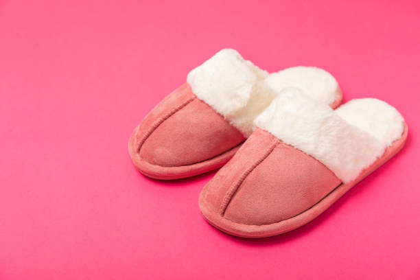 istock Soft slippers on a bright colored background, close-up. House slippers. Comfortable shoes for home. Foot care concept. Home comfort. Space for text. Copy space. 2187260962