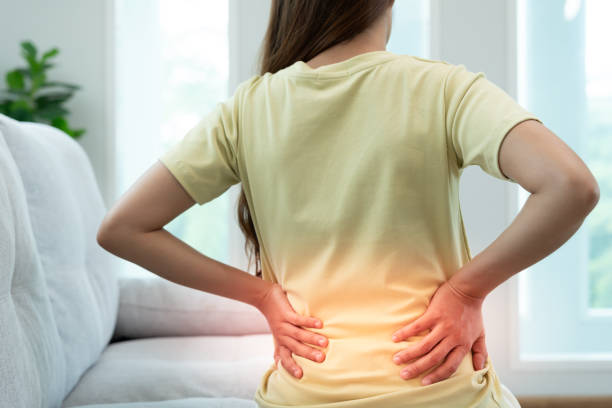 istock woman holding her lower back while and suffer from unbearable pain health and problems, chronic back pain, backache in office syndrome, scoliosis, herniated disc, muscle inflammation 2187261959
