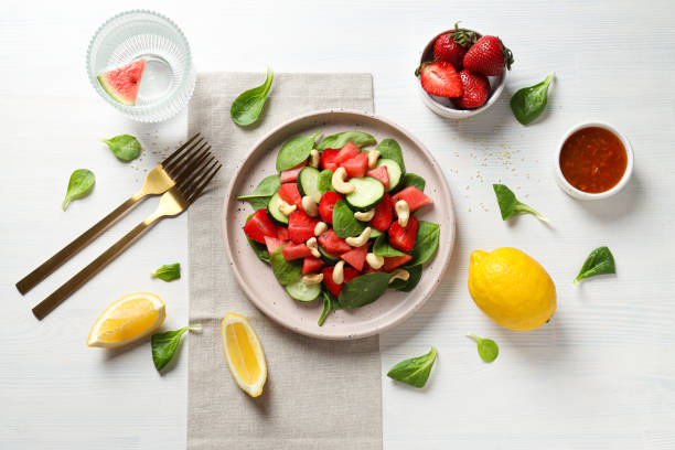 istock Fresh watermelon salad in a bowl with lemon and strawberries on the table 2187262814