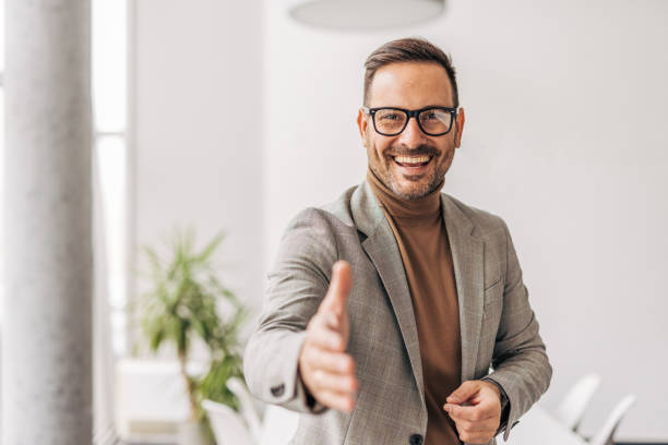 istock A smiling businessman offers a handshake 2187263922
