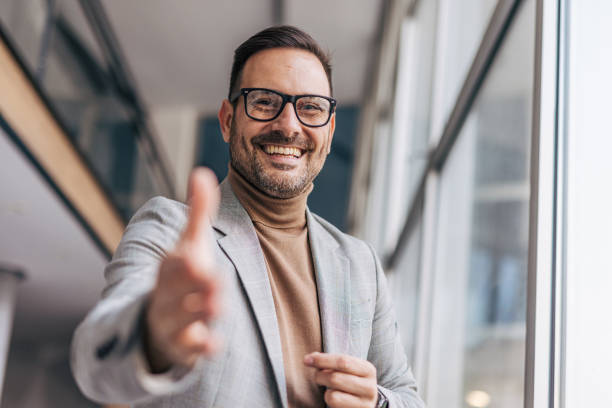 istock A smiling businessman offers a handshake 2187265006