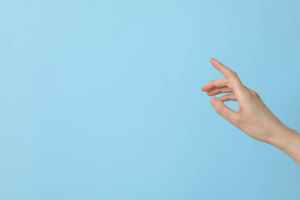 istock Female well-groomed hand on a light blue background, place for text 2187265089