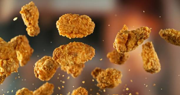 istock Fried Chicken Pieces Flying up in the Air. 2187265209
