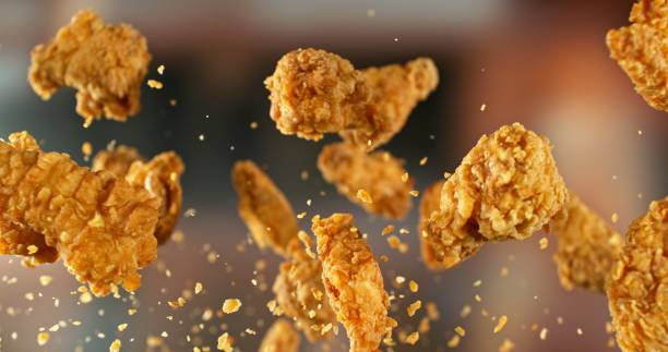istock Fried Chicken Pieces Flying up in the Air. 2187265234