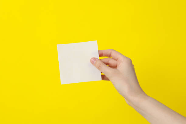 istock A white, blank piece of paper in a woman's hands 2187265475