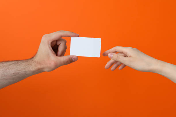 istock Female and male hand with blank paper 2187266302