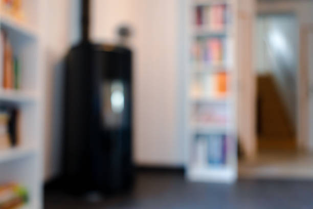 istock Blurred pellet stove in a living room with bookcase and heat diffuser for backgrounds use 2187267023