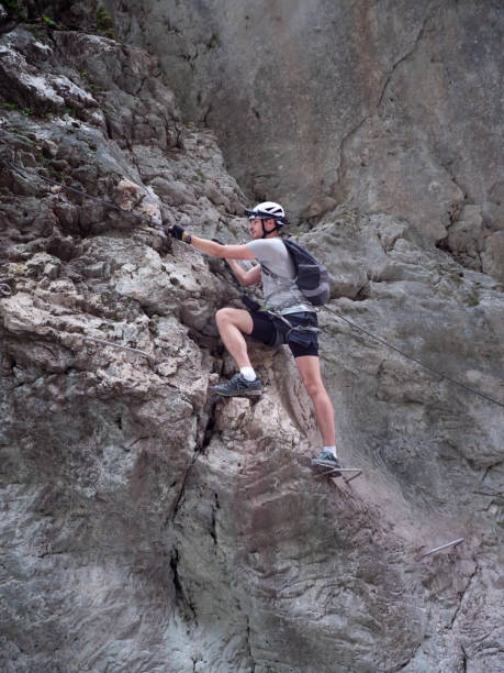 istock A climber climbing a rock on a via ferrata. 2187267681