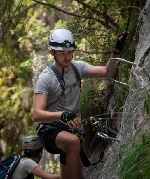istock A male climber climbing a via ferrata using the metal steps. 2187267730