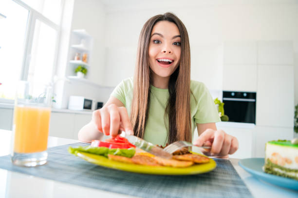 istock Young woman girl joyfully enjoying a nutritious meal in a modern kitchen setting 2187267995