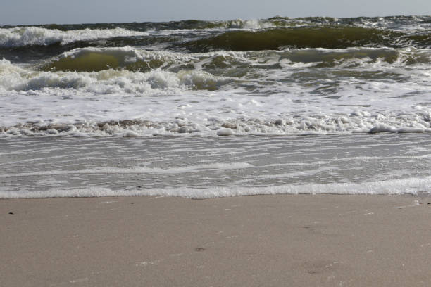 istock Waves Crashing on Sandy Beach Shoreline 2187268215