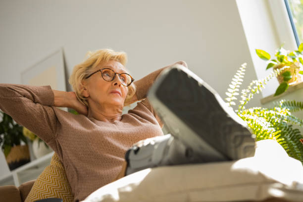 istock Worried senior woman with broken leg 2187268964