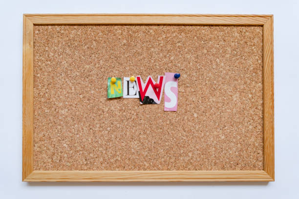 News word pinned on cork board