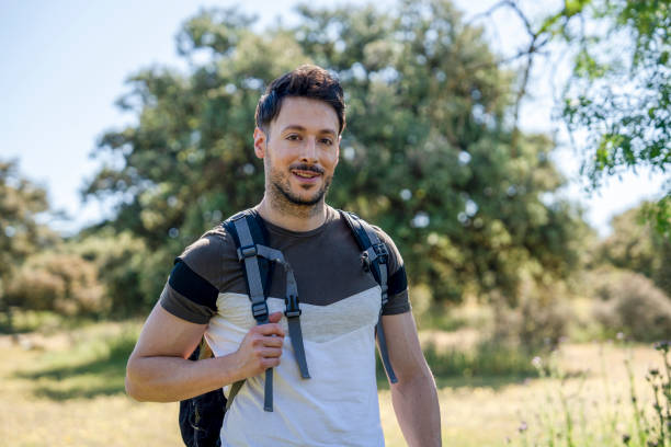 istock Young explorer hiking through serene natural surroundings 2187270300